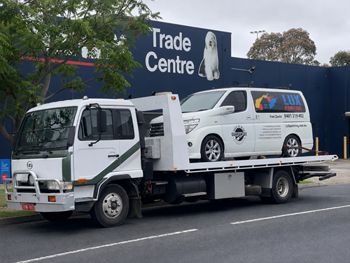 Naser Towing flatbed tow truck loaded and ready